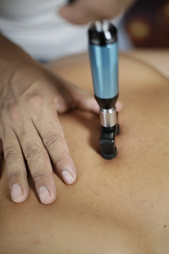 Detailed close-up of chiropractic adjustment therapy on a patient's back.